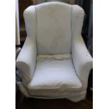 A wingback armchair with loose covers