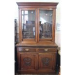 An Edwardian mahogany cupboard bookcase with two door,