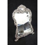 A silver floral embossed mirror