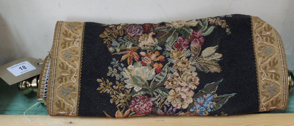 A floral tapestry scroll hanging