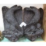 A pair of carved wooden eagle wall plaques,