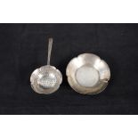 A continental silver tea strainer and dish