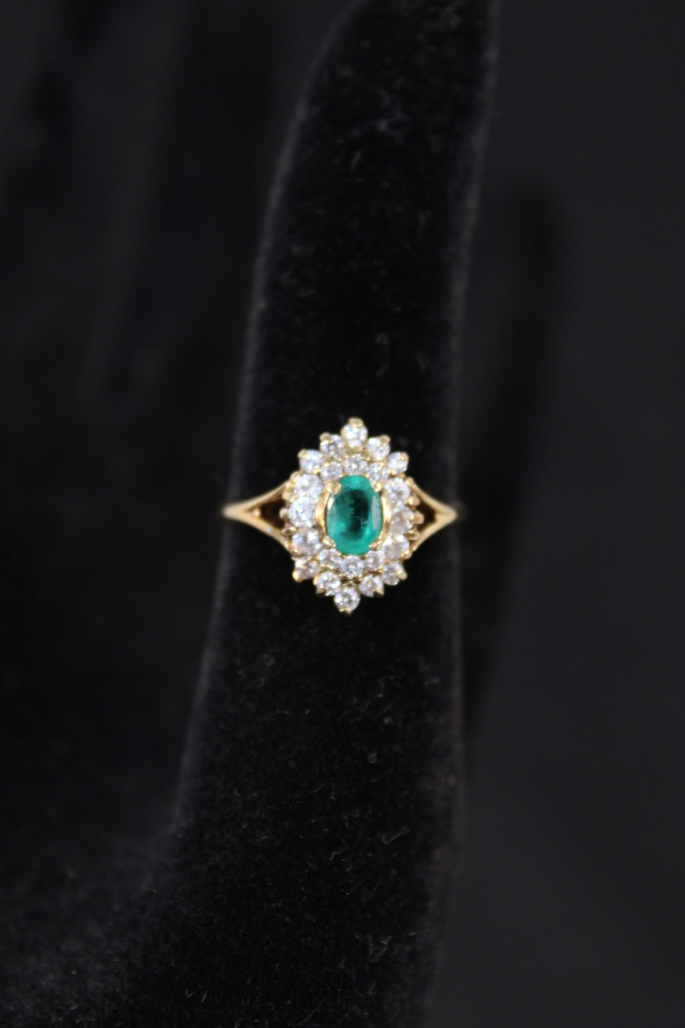 A 14ct gold emerald and diamond cluster ring,