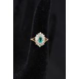 A 14ct gold emerald and diamond cluster ring,