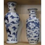 Two 19th Century Chinese blue and white dragon and Dog of Fo vases (chipped top rims)