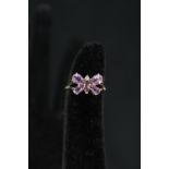 A 9ct gold ring set with amethyst and small diamond in butterfly form,