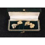 A pair of gold cufflinks of playing card design with heart, club,