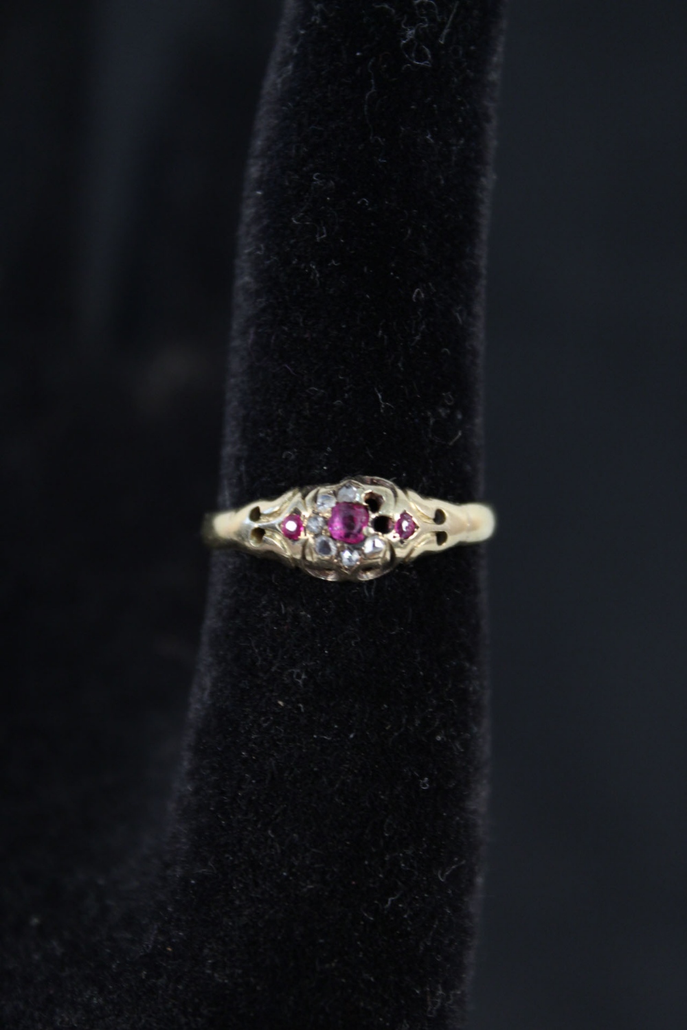 An unmarked gold ring with rubies and diamonds in small cluster setting (as found),