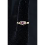 An unmarked gold ring with rubies and diamonds in small cluster setting (as found),