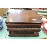 A mahogany four drawer coin cabinet