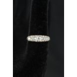 An 18ct platinum set five stone diamond ring with intricate scroll setting,
