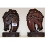 A pair of carved wooden horse bookends