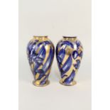 A pair of Edwardian gilt and blue floral vases,