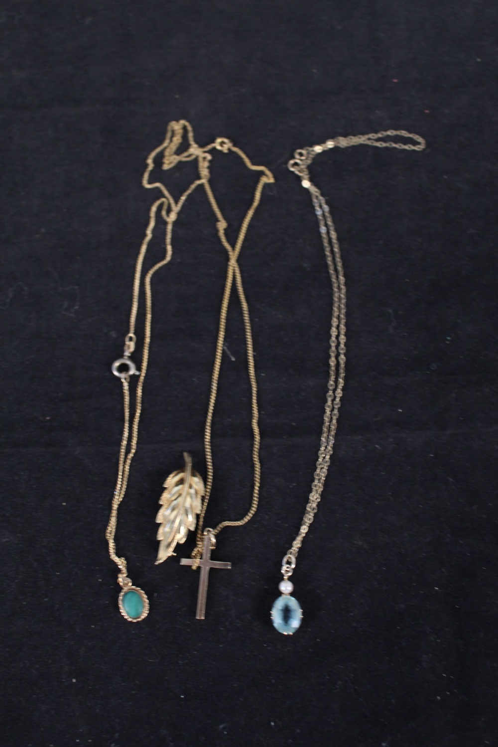 A 9ct gold cross on chain, a 9ct gold aquamarine and pearl set pendant on chain,