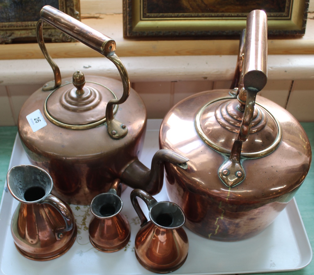 Two 19th Century circular seamed copper kettles plus a set of three small graduated copper measures