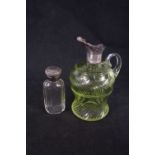 A silver topped scent bottle and a small coloured glass decanter/jug with silver collar (no