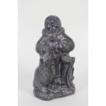 A Wolf inuit stone carving of a man, dog and bear cub,