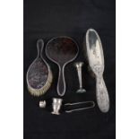 A silver and tortoiseshell mirror and brush, another silver backed brush, a pair of sugar tongs,