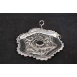 An Indian white metal dish with embossed village scene to centre with handle