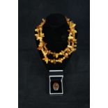 An amber bead necklace and silver ring set with amber