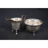 A silver cream jug and matching sugar bowl together with a set of six continental spoons stamped