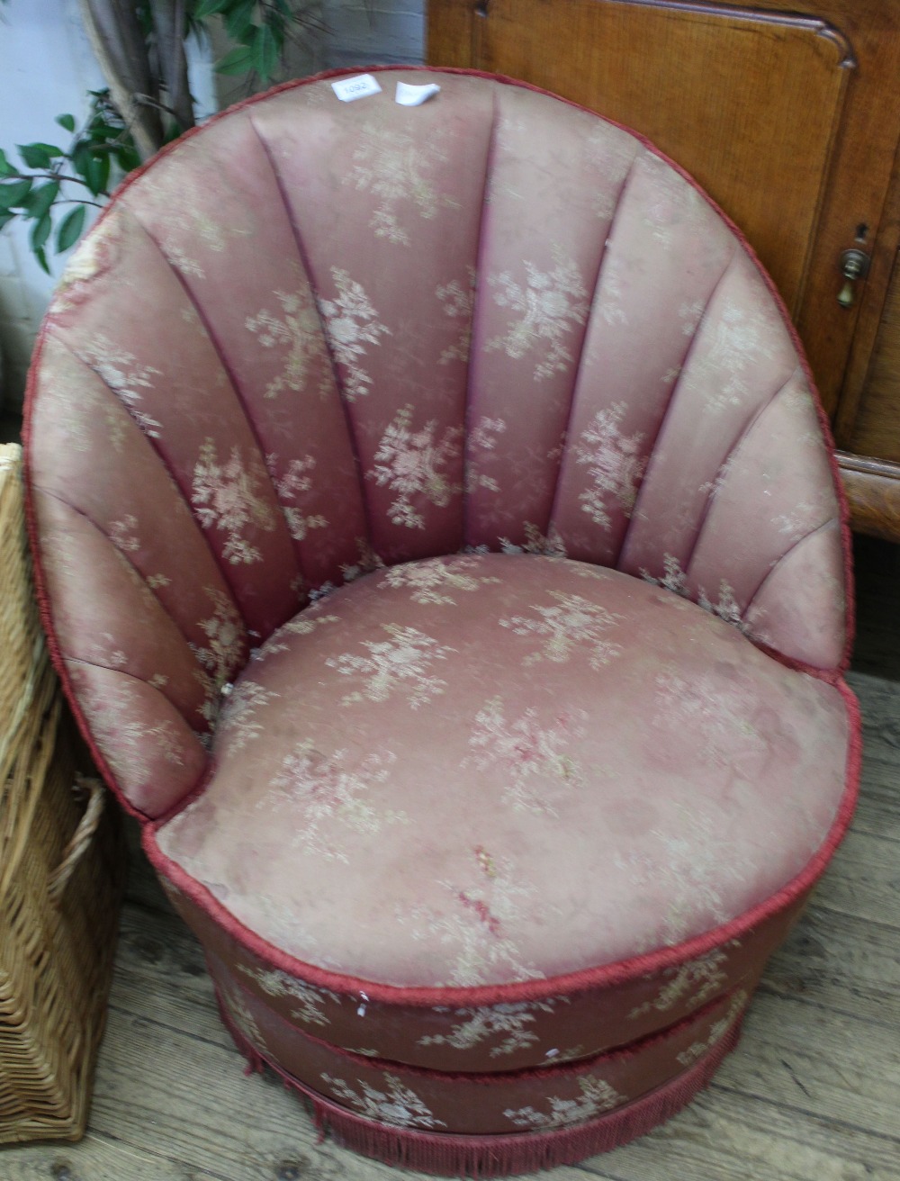 A 1950's curved back upholstered tub chair