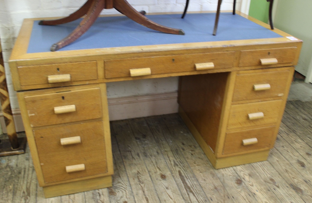 A 1940's oak nine drawer three part desk