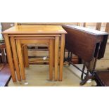A nest of yew occasional tables and a small oak drop leaf table