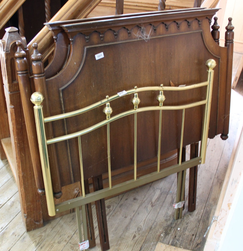 A brass single bed headboard and two wooden other single bed headboards