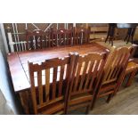 A rustic style kitchen table and six metal chairs