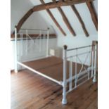 A white painted and brass double bed frame