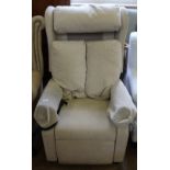 A nearly new Clivedon R&R cream upholstered electric reclining armchair