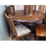 An Old Charm extending oak dining table and four chairs