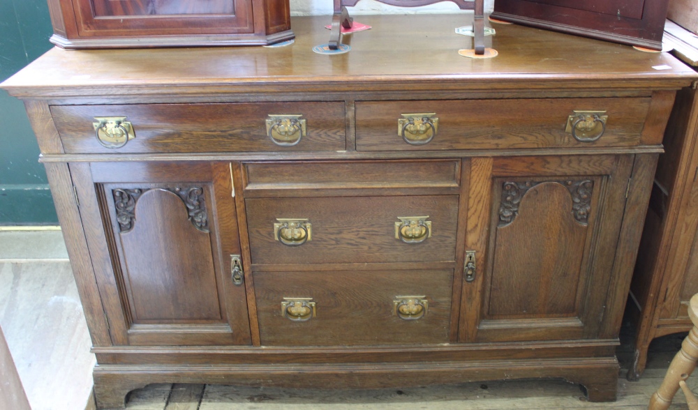 A large Edwardian oak five drawer,