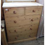 A pine chest of two short and three long drawers