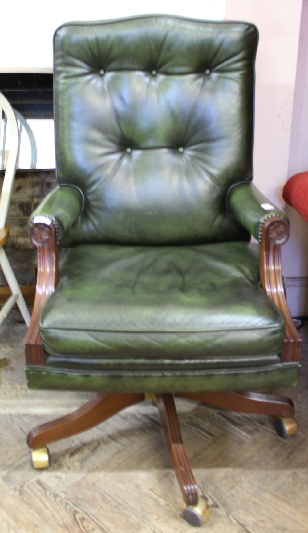 A reproduction mahogany and leather upholstered office chair