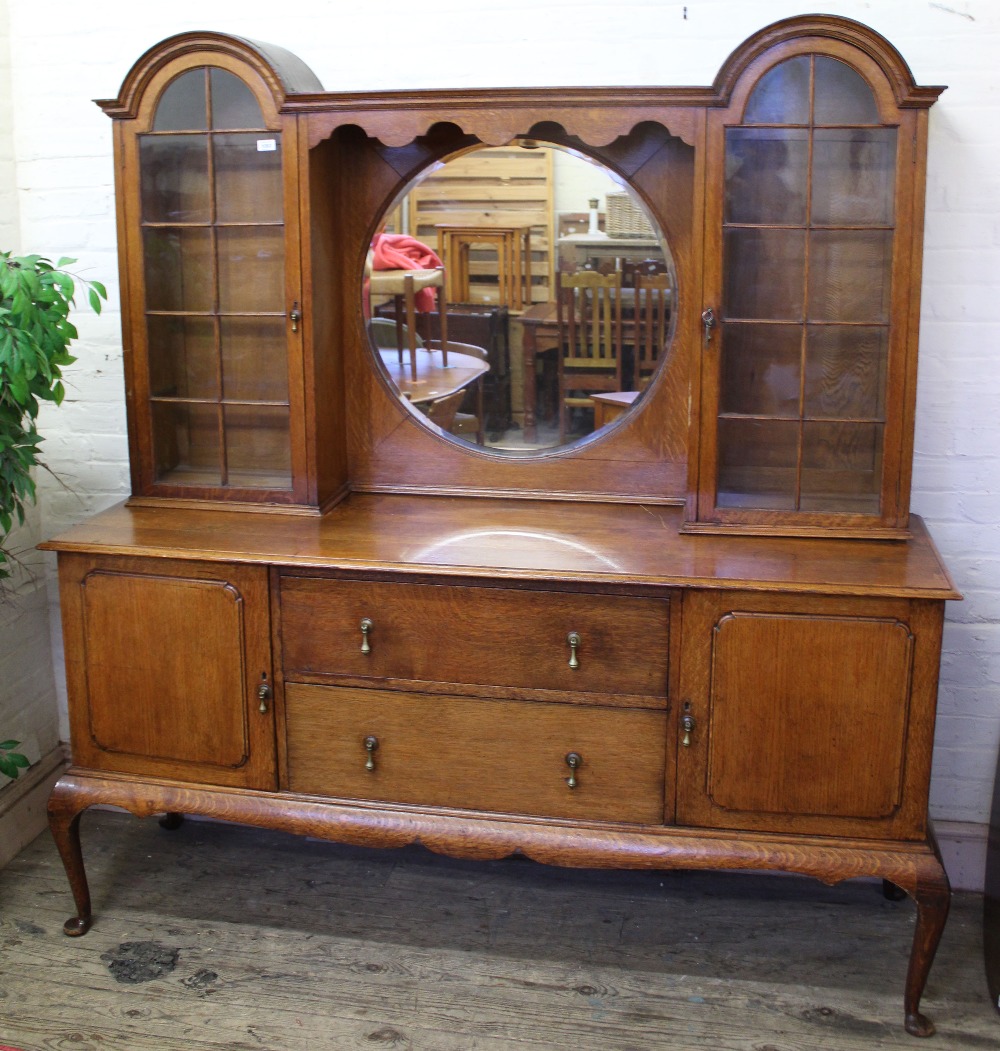 A 1920's Dutch style oak sideboard with mirror and glazed top over two door,