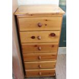 A modern pine narrow six drawer chest