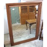 A large rectangular mahogany effect wall mirror