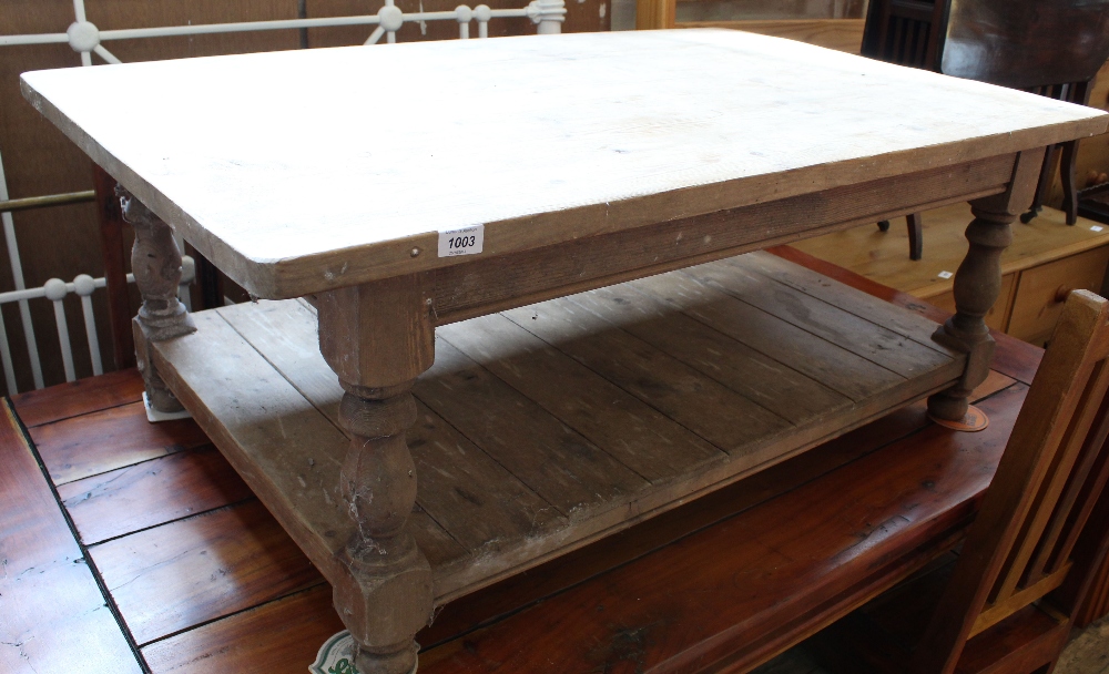 A stripped pine coffee table with under tier