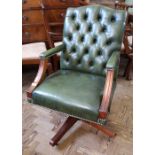 A reproduction mahogany and green leather back office chair