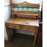 A reproduction pine two drawer washstand with green tiled upstand