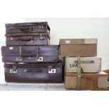 Various vintage leatherette suitcases and cardboard storage boxes