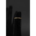 A 22ct gold band ring (worn),