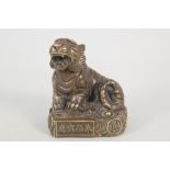 A Chinese bronze seated tiger with seal mark and calligraphy,