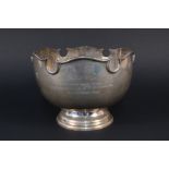 A large silver bowl with wavy edge rim on pedestal base, with presentation inscription,