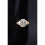 A gents 9ct gold signet ring with engraved detail,