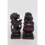 A pair of 19th Century carved mahogany heraldic lions,