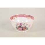 A Chinese porcelain tea bowl and saucer with flower and ribbon pattern and deep pink border