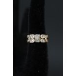 A 9ct gold ring with unusual panel design set with diamonds,